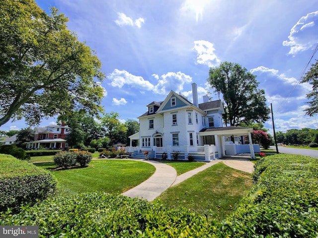 victorian home featuring a front yard and covered porch