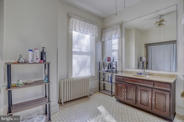 bathroom featuring radiator, vanity, and ceiling fan