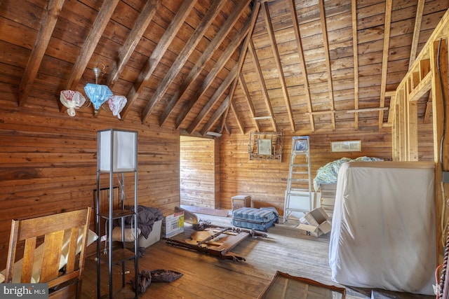 interior space featuring vaulted ceiling with beams, wood-type flooring, wooden walls, and wood ceiling