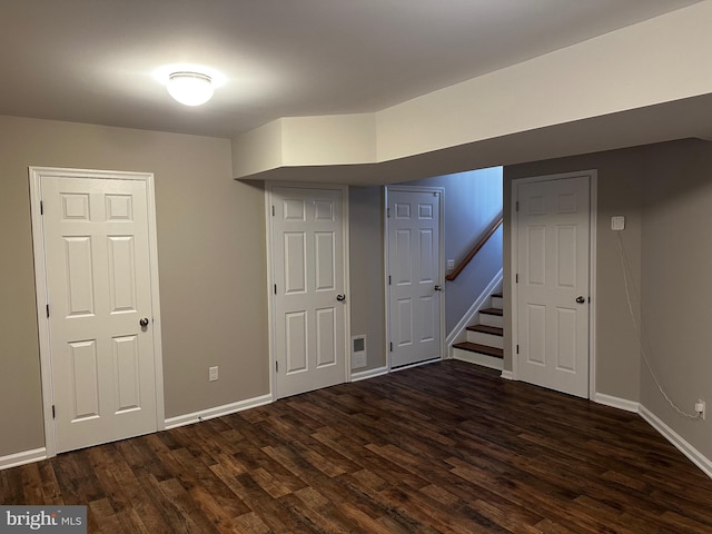 basement with dark hardwood / wood-style flooring