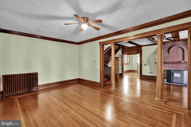 unfurnished living room featuring crown molding, hardwood / wood-style floors, radiator, and ceiling fan