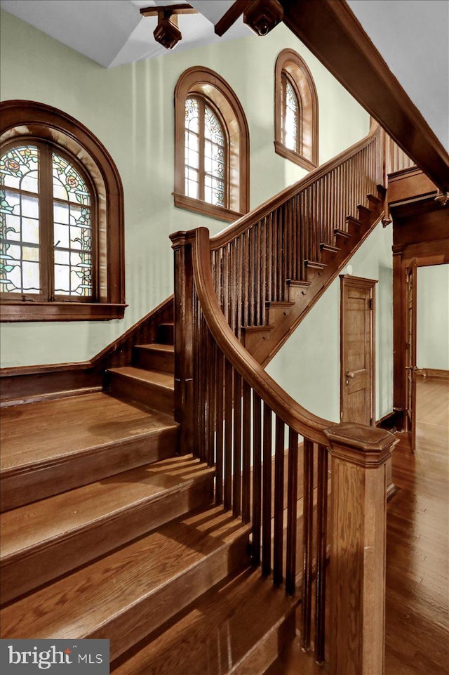 stairs featuring hardwood / wood-style floors