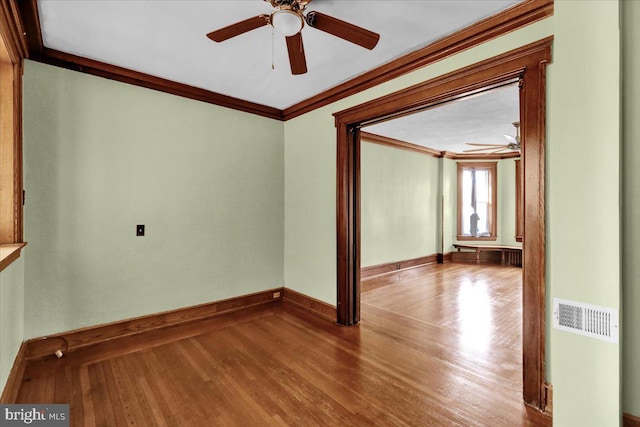 unfurnished room featuring ornamental molding, hardwood / wood-style flooring, and ceiling fan