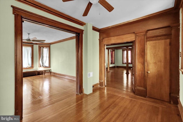 spare room featuring hardwood / wood-style floors, crown molding, and ceiling fan