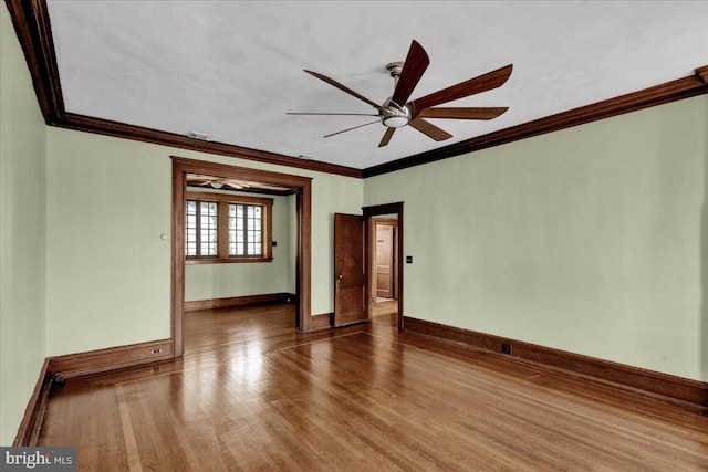 spare room with ceiling fan, hardwood / wood-style flooring, and ornamental molding