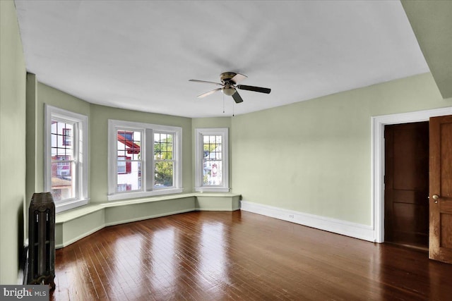 spare room with hardwood / wood-style floors, a healthy amount of sunlight, and ceiling fan