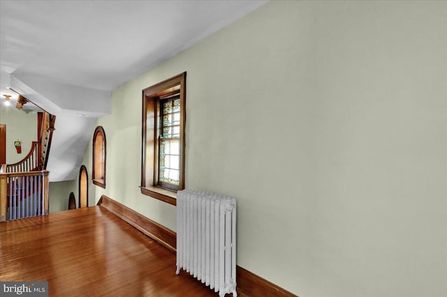 interior space featuring wood-type flooring and radiator