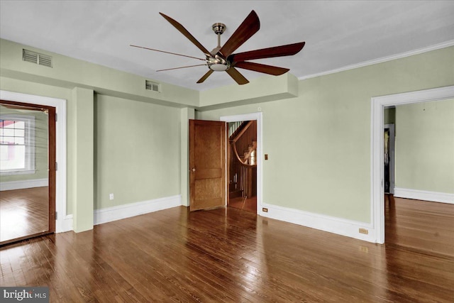 spare room with crown molding, dark hardwood / wood-style flooring, and ceiling fan