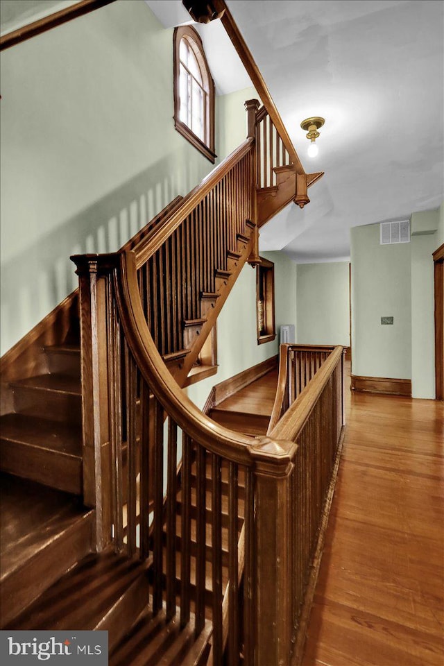 stairway featuring wood-type flooring