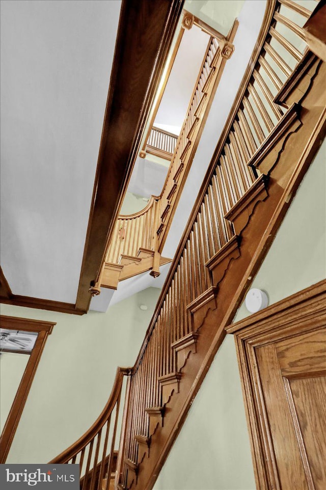 stairs featuring a towering ceiling