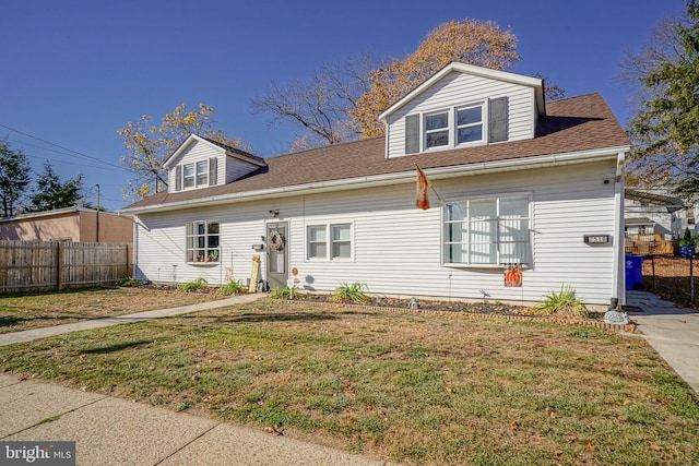 cape cod home with a front yard