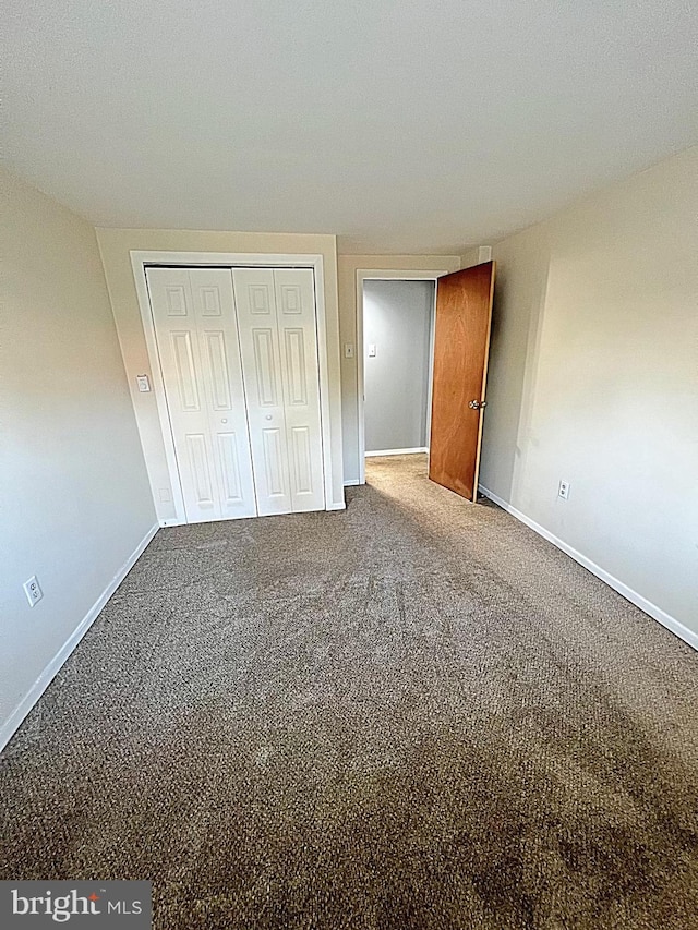 unfurnished bedroom with a closet and carpet