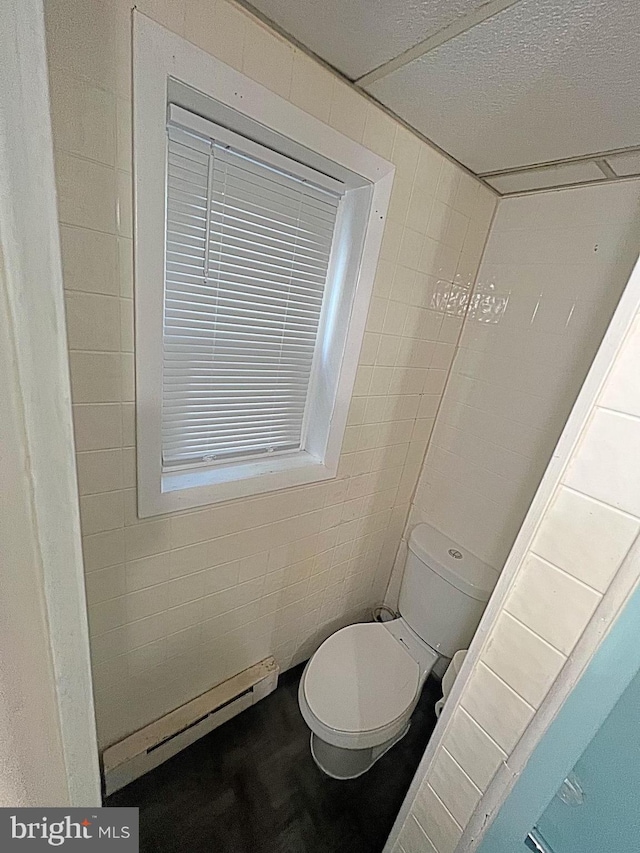 bathroom with a baseboard radiator and toilet