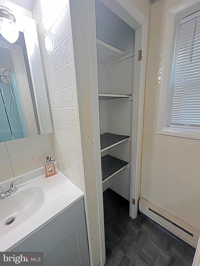 bathroom with vanity and a baseboard radiator