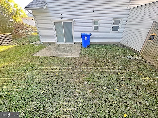 rear view of house with a lawn and a patio area