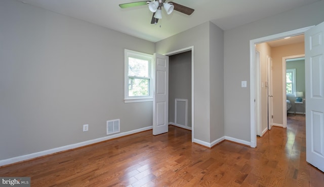 unfurnished bedroom featuring hardwood / wood-style flooring and ceiling fan