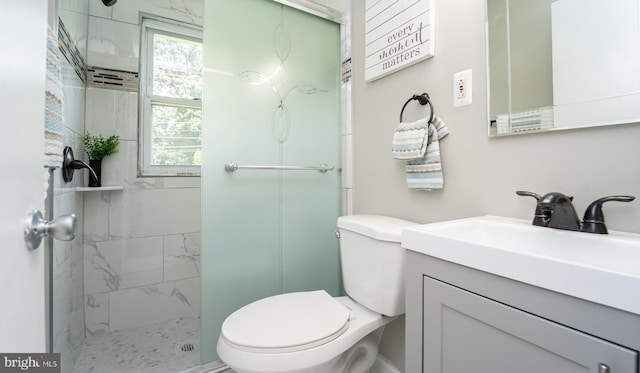 bathroom featuring vanity, toilet, and an enclosed shower