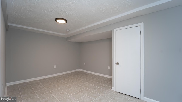 unfurnished room featuring a textured ceiling