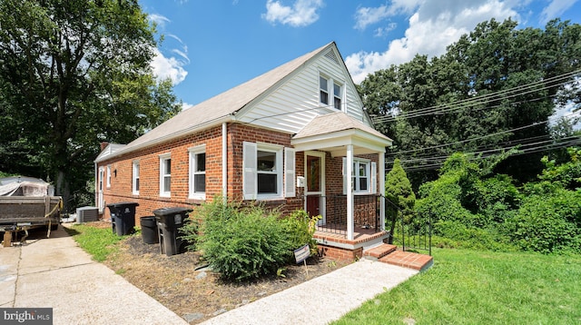 view of front of home with a front lawn and central AC unit