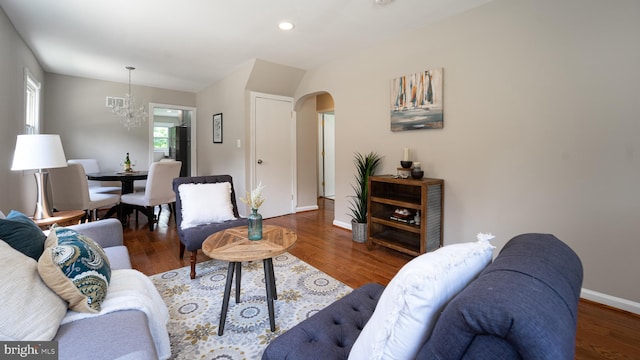 living room with a chandelier and dark hardwood / wood-style flooring