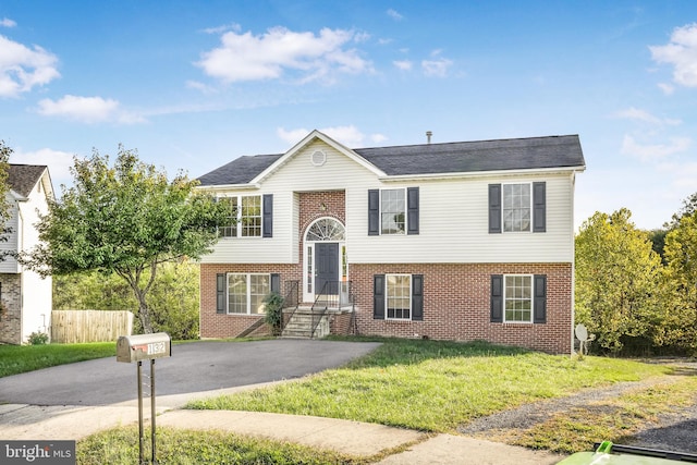 bi-level home with a front lawn