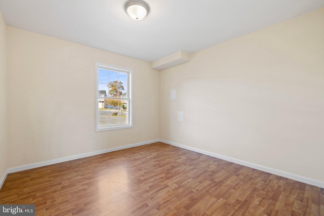 spare room with hardwood / wood-style flooring