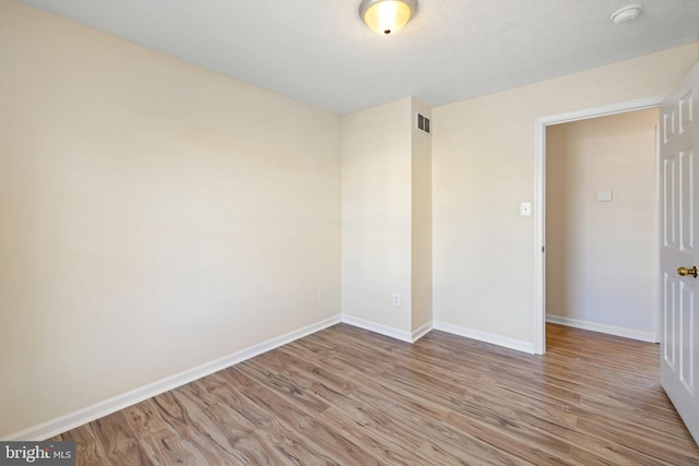 spare room featuring light wood-type flooring