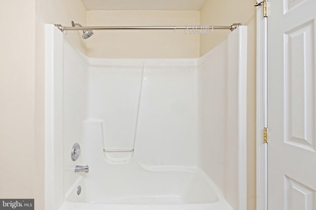 bathroom featuring a textured ceiling and shower / bath combination