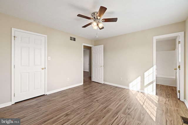 unfurnished bedroom with ceiling fan and light hardwood / wood-style flooring