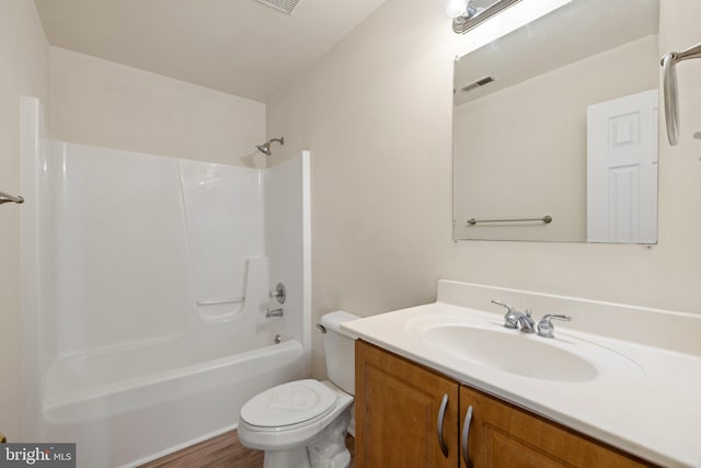 full bathroom with toilet, vanity, hardwood / wood-style flooring, and shower / bathtub combination