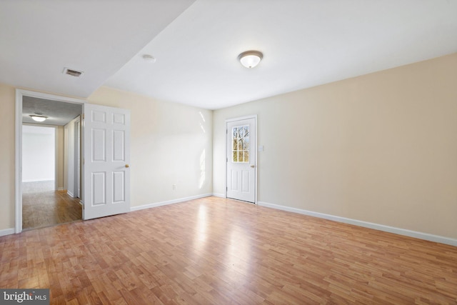 empty room with light hardwood / wood-style floors