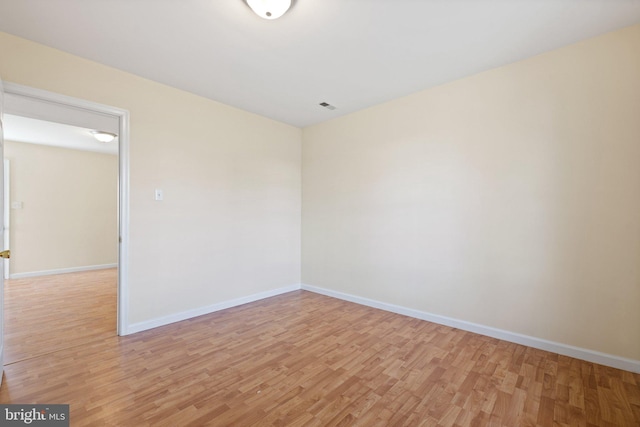 spare room with light hardwood / wood-style flooring