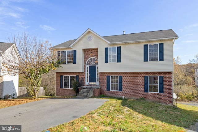 bi-level home with a front lawn