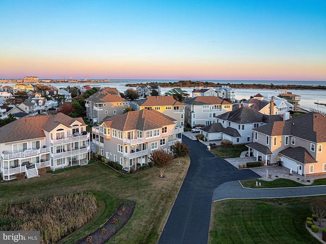 aerial view at dusk with a water view