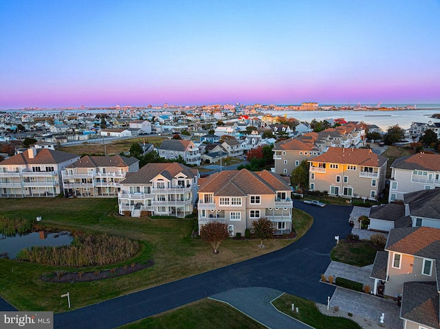 aerial view at dusk with a water view