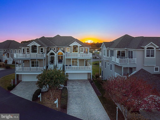 view of front of property featuring a garage and a balcony