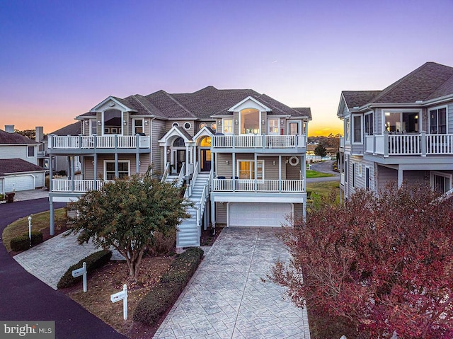 view of front of house featuring a garage and a balcony