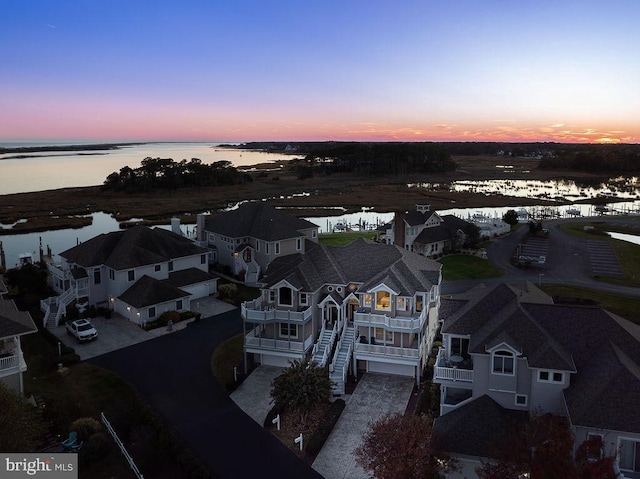 aerial view at dusk with a water view