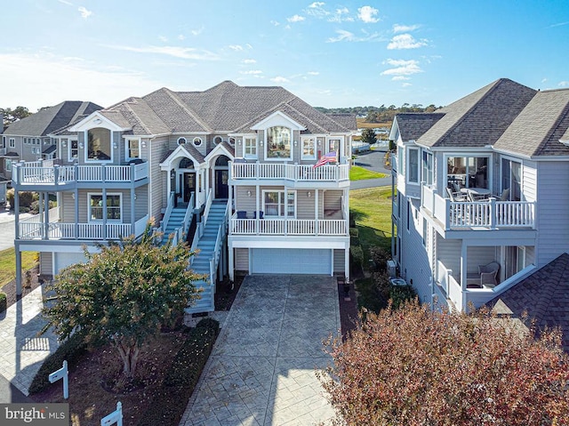 view of front facade with a garage and a balcony