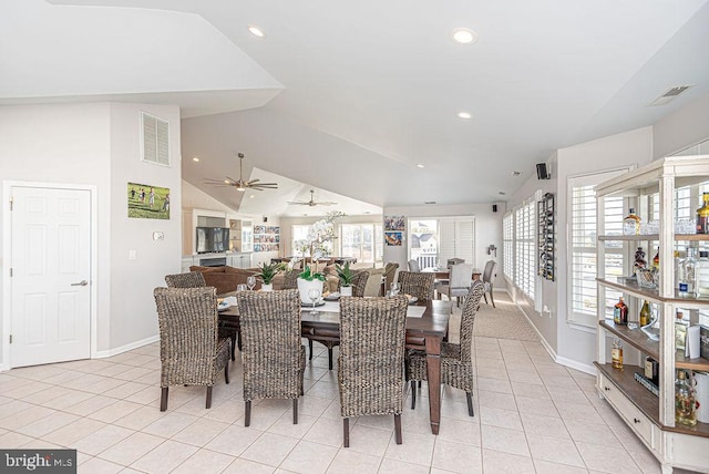 tiled dining area featuring lofted ceiling and ceiling fan