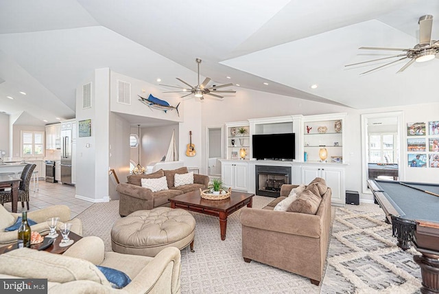 living room with built in shelves, ceiling fan, light tile patterned floors, and billiards