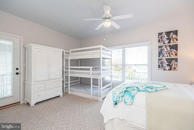 bedroom featuring ceiling fan, carpet, and access to outside