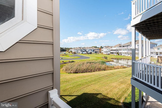 view of yard with a water view and a balcony