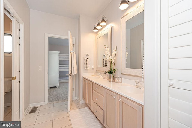 bathroom featuring tile patterned flooring, vanity, and toilet