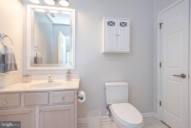 bathroom featuring toilet, vanity, and tile patterned floors