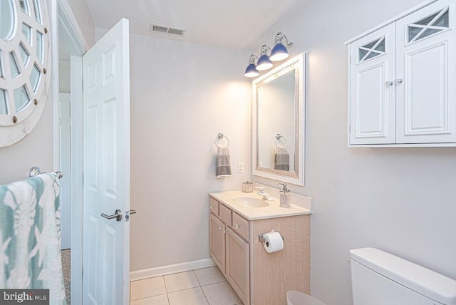 bathroom with vanity, tile patterned flooring, and toilet