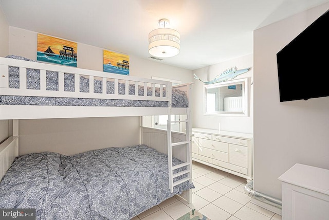 bedroom with light tile patterned floors