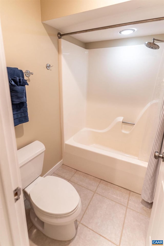 bathroom featuring toilet, tile patterned floors, and washtub / shower combination