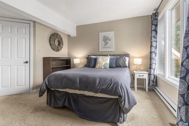 bedroom with carpet flooring, multiple windows, and a baseboard heating unit