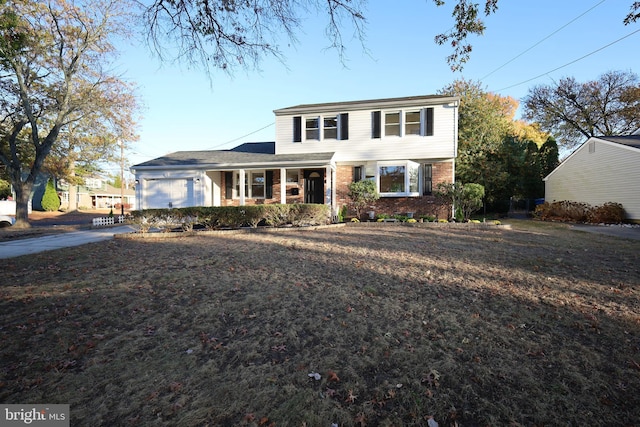 front of property featuring covered porch and a garage